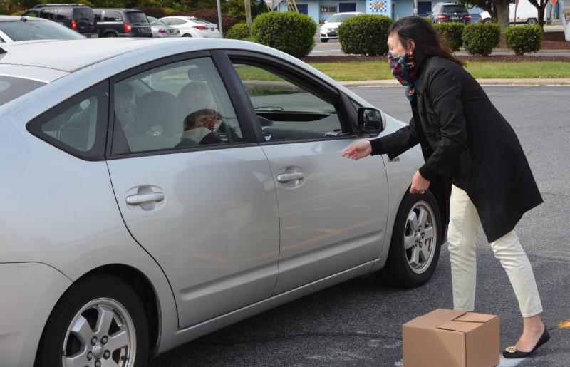 State Auditor Kathy McGuiness helps a recipient fill out the paperwork.